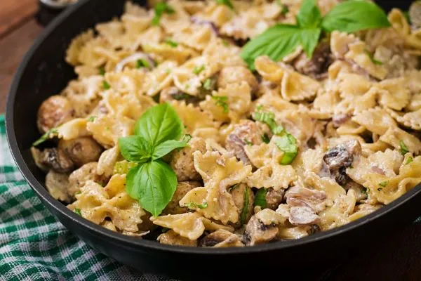Plate of mushrooms and pasta covered in sauce